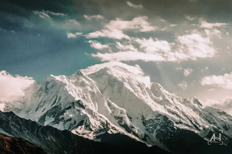A snow-covered peak breaking through cloud in the Karakoram