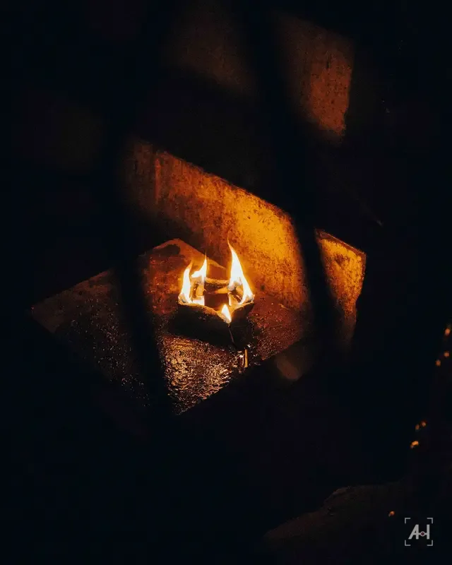Oil lamps burning in a stone niche in the dark