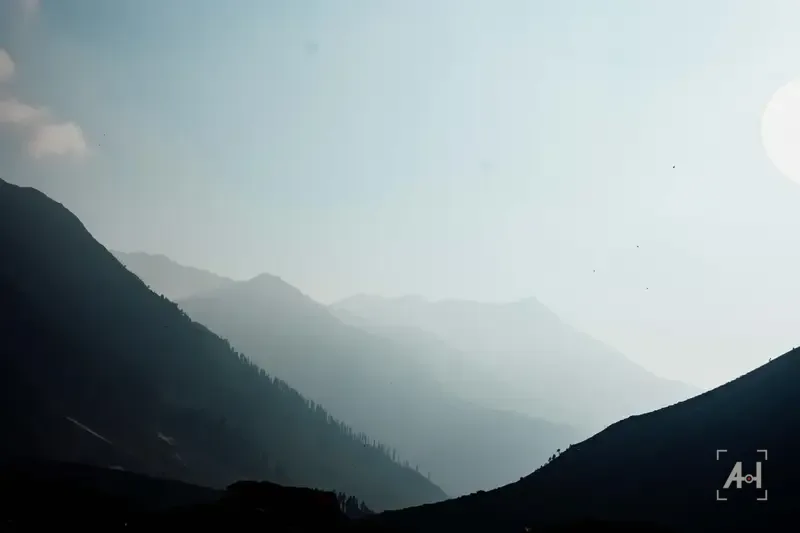 Layered mountain ridges fading into haze