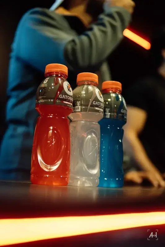 Three Gatorade bottles at table height, an orange light line below