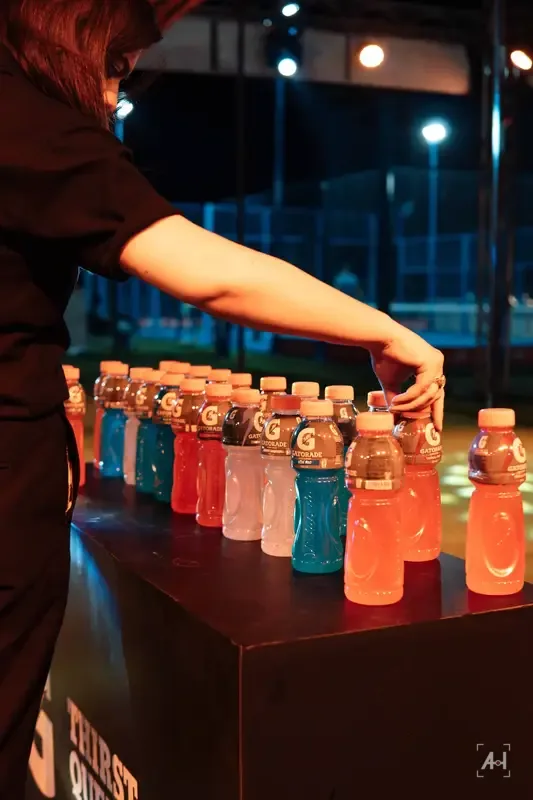 Lining up Gatorade bottles on a black plinth at the Thirst Quencher night