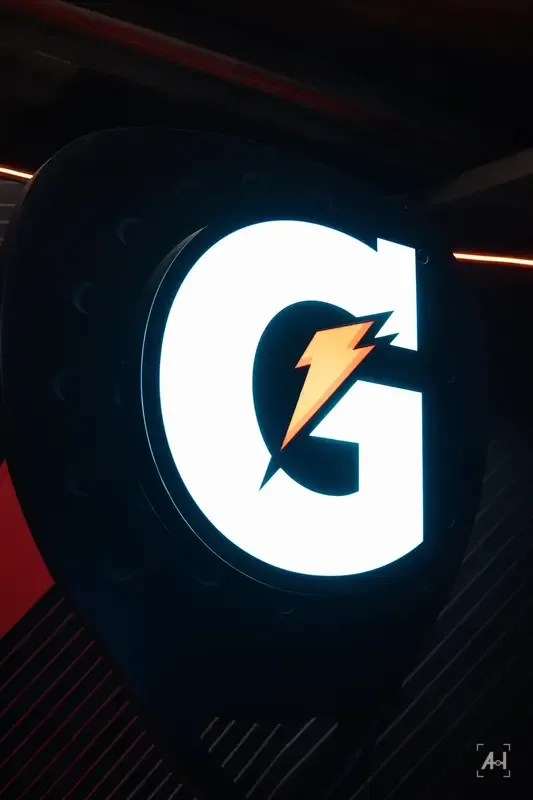 The illuminated Gatorade G on a black sign