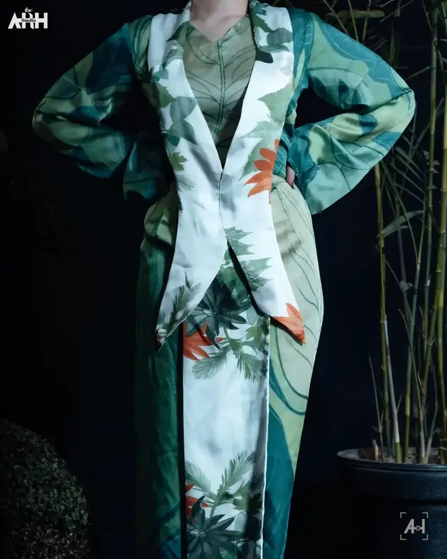 The Enchanted suit in close-up, hands at the lapel