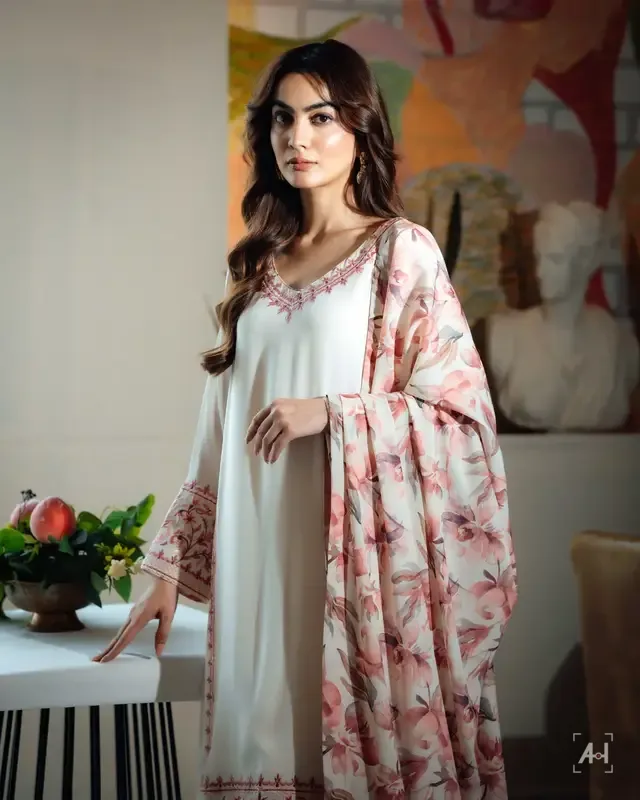 A white embroidered suit with a printed dupatta in a sunlit room, for KTF