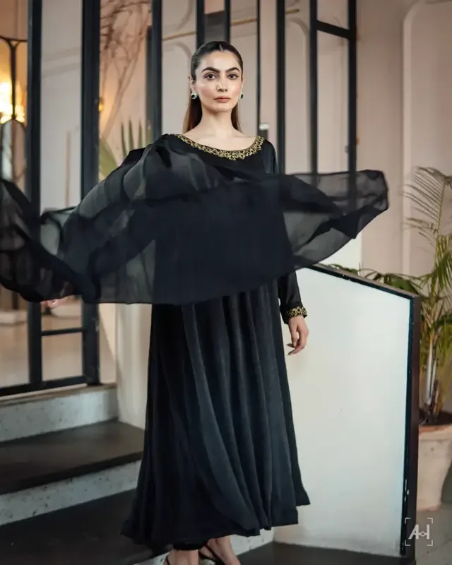 A black KTF kaftan on a staircase