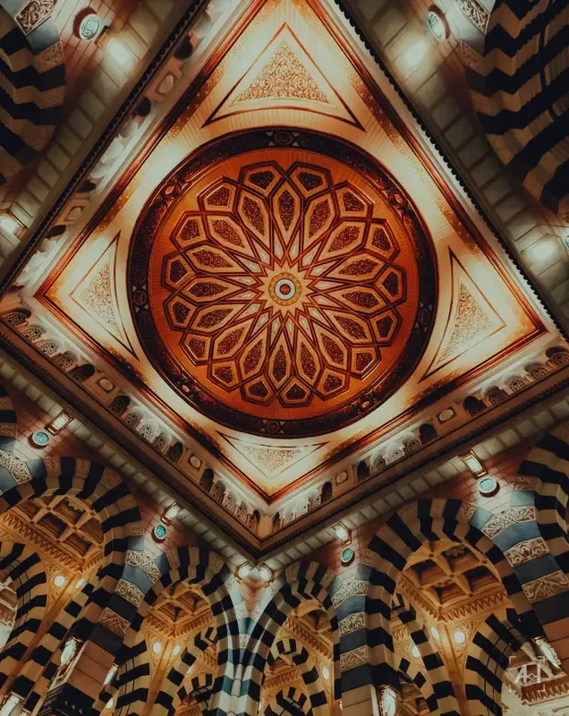 An ornate painted dome ceiling inside the Prophet's Mosque
