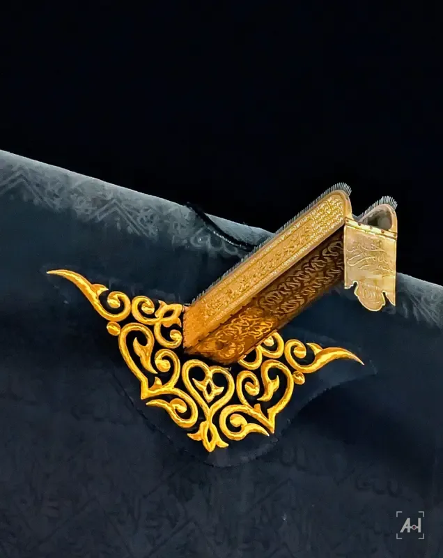 The golden spout of the Kaaba above gold embroidery on the black kiswa