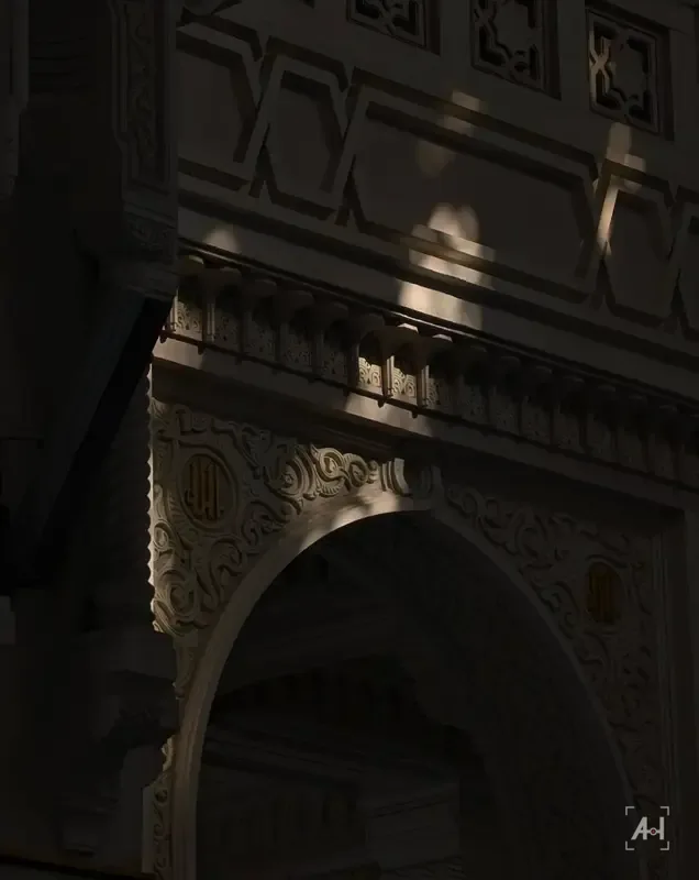 Sunlight falling across a carved arch in shadow