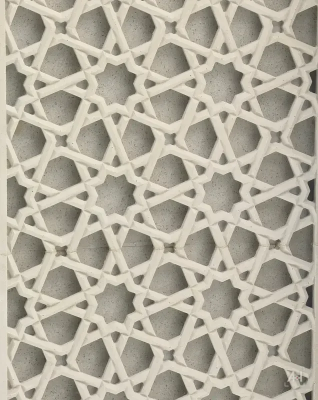 Carved geometric star lattice in white stone