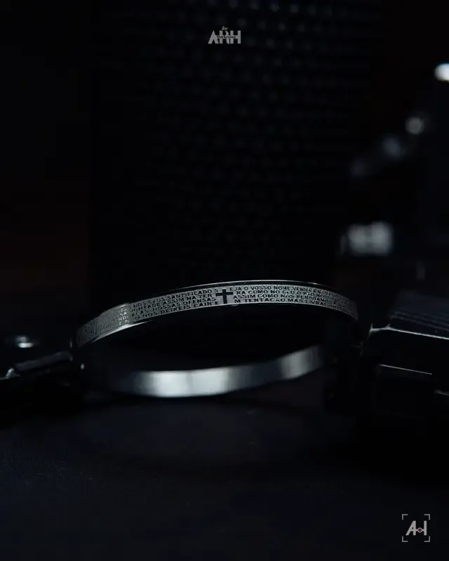 The engraved prayer bangle resting in low side light