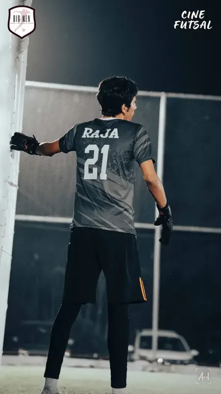 Goalkeeper Raja, number 21, holding the post under the floodlights
