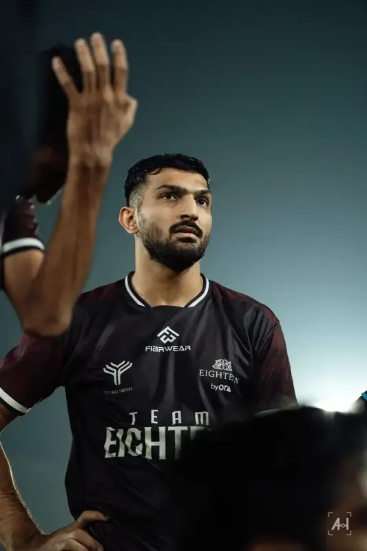 A Team Eighteen player looking up during a Football Factory huddle