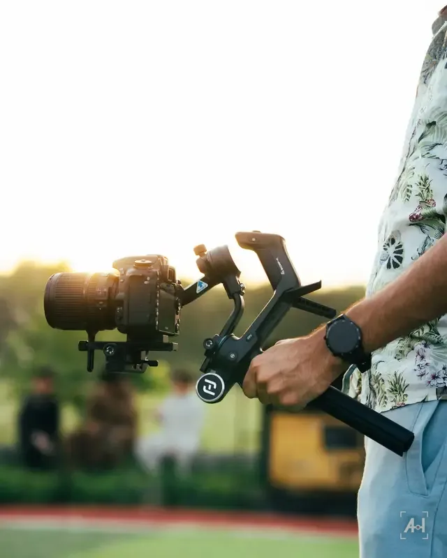 A camera on a gimbal at golden hour on the touchline