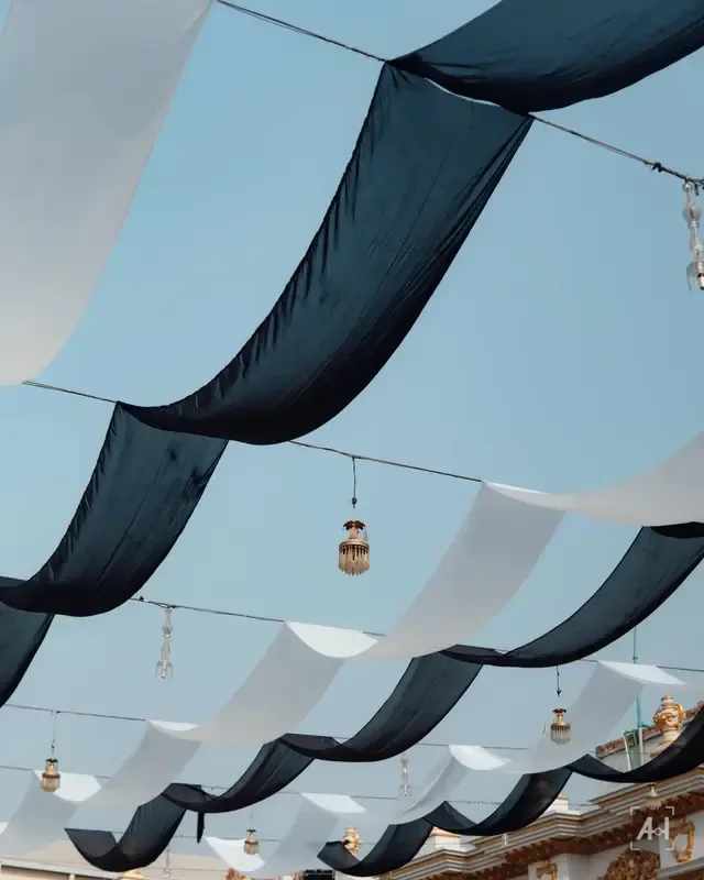 White and navy drapes over the courtyard, lanterns hanging