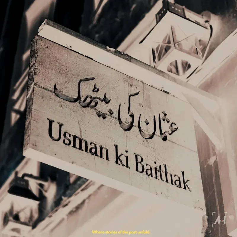 The carved wooden sign for Usman ki Baithak in Urdu and English